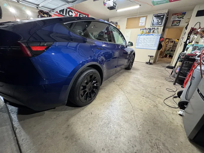 Blue Tesla Model Y rear three-quarter gloss
